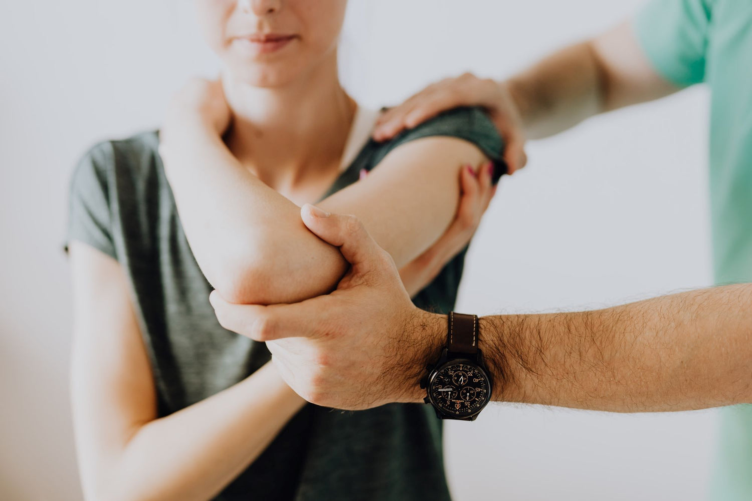 woman receiving chiropractor therapy on elbow joint pain