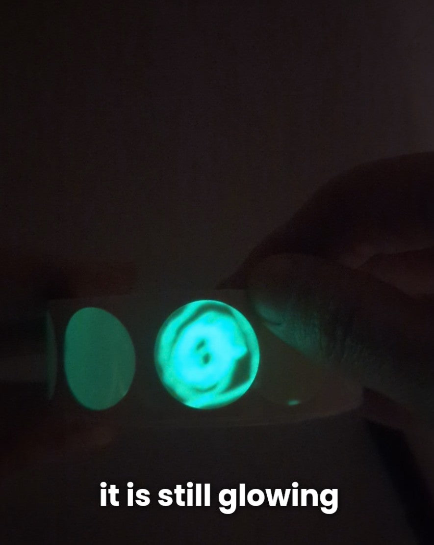 violet and purple laser pointer of 405 nm lights up a glow in the dark fluorescent sticker in an at home DIY physics experiment from laser Classroom